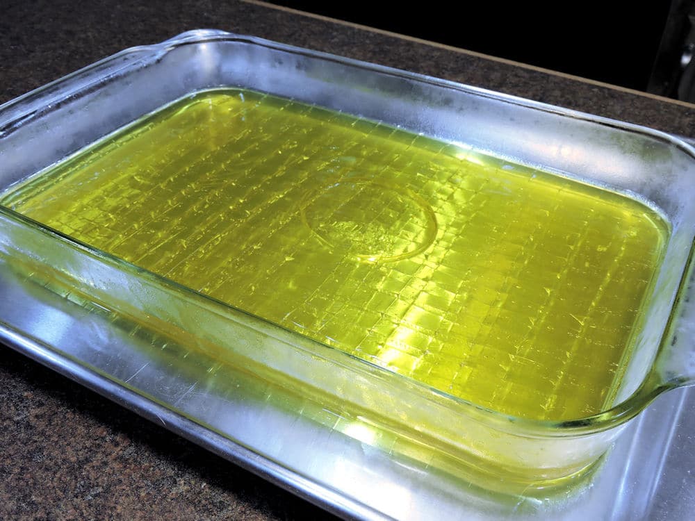 refrigerated lemon jello squares ready for cutting.