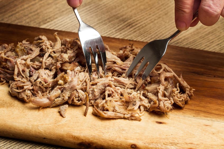 two forks shredding meat on a cutting board © merazul via 123rf.com