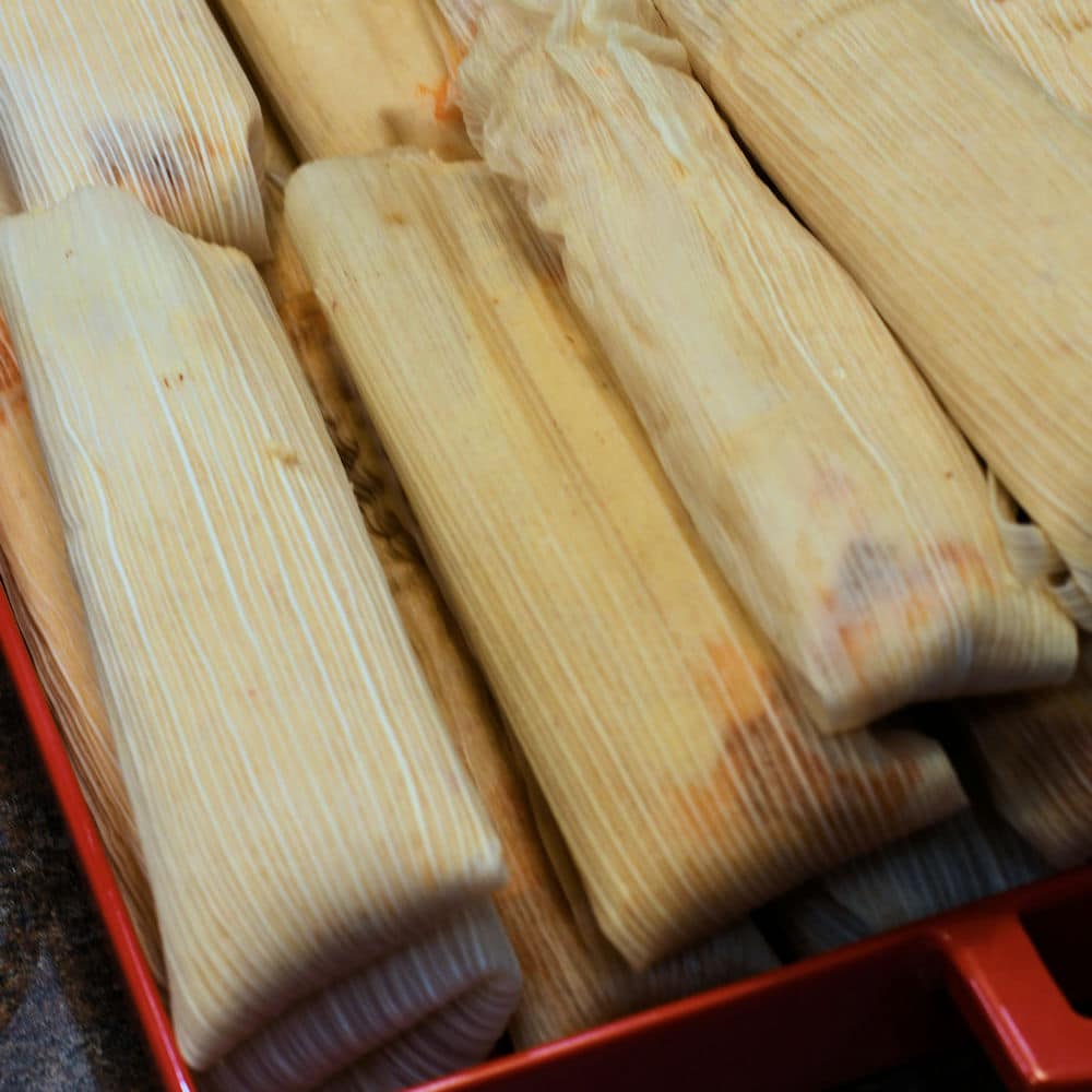take the tamales out of the steamer and place in a large tray to cool