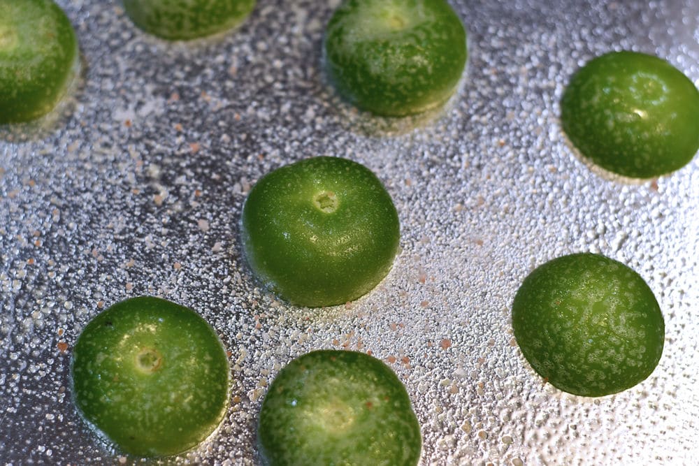 24Bite: Halved tomatillos on sheet pan ready for roasting