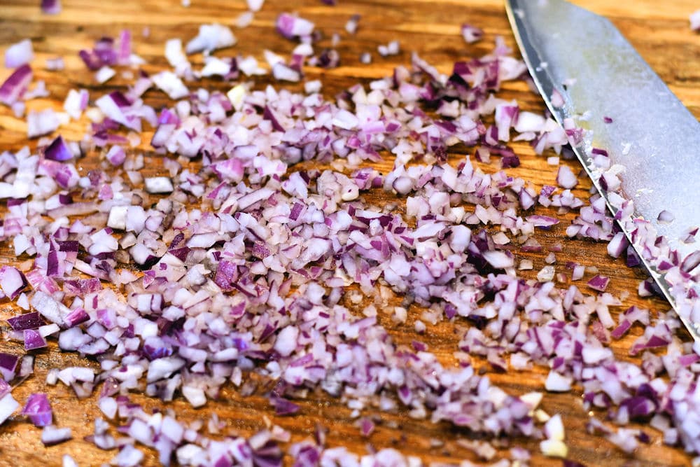 finely chopped red onion on cutting board