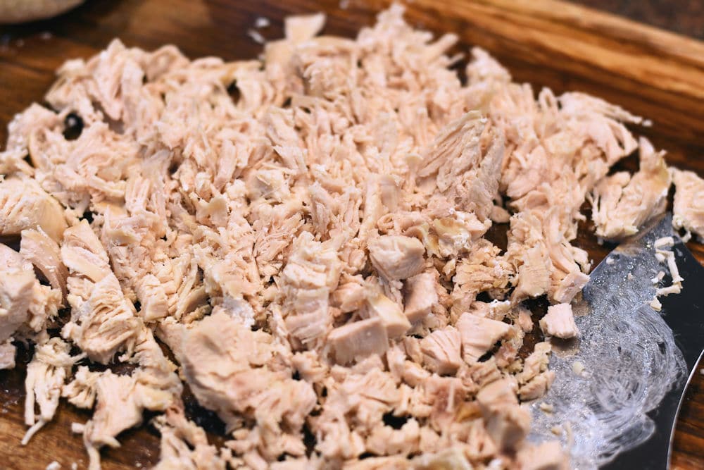 24Bite: Shredding boneless chicken breast with an ulu knife on cutting board