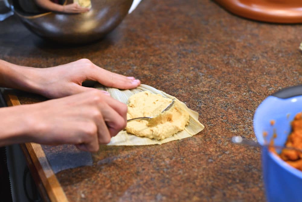 24Bite: sperading masa dough on corn husk for vegan tamales