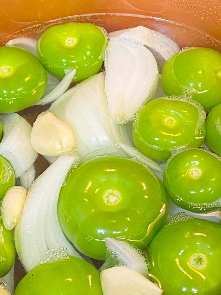 24Bite: green tomatillos, onion and garlic in water to boil in a sauce pan for salsa verde