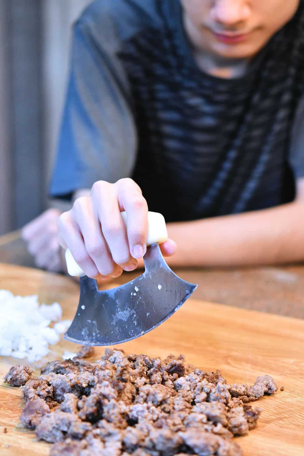 24Bite: Christian Guzman chopping cooked ground beef with ulu knife