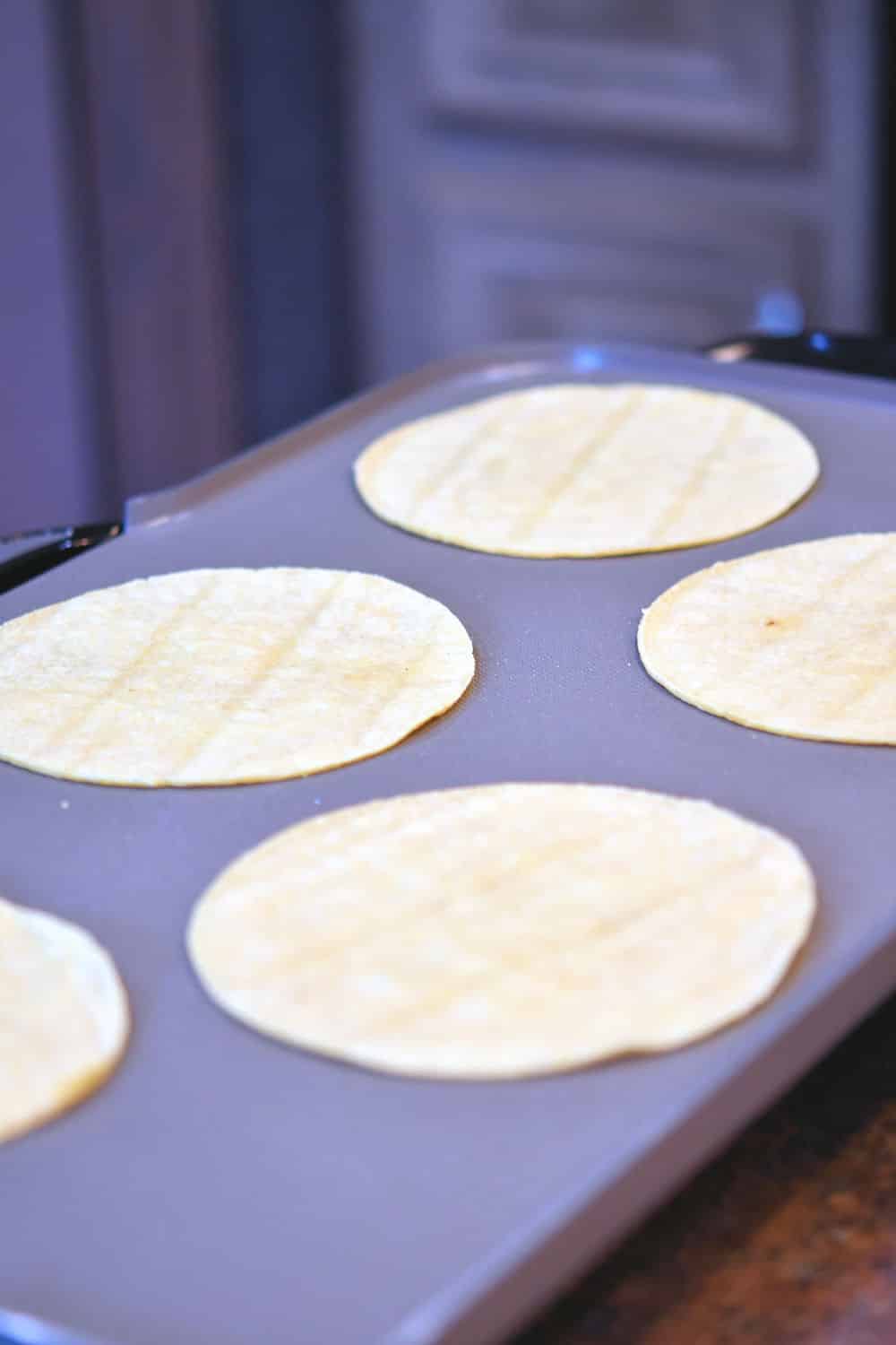 24Bite: corn tortillas cooking on an electric griddle
