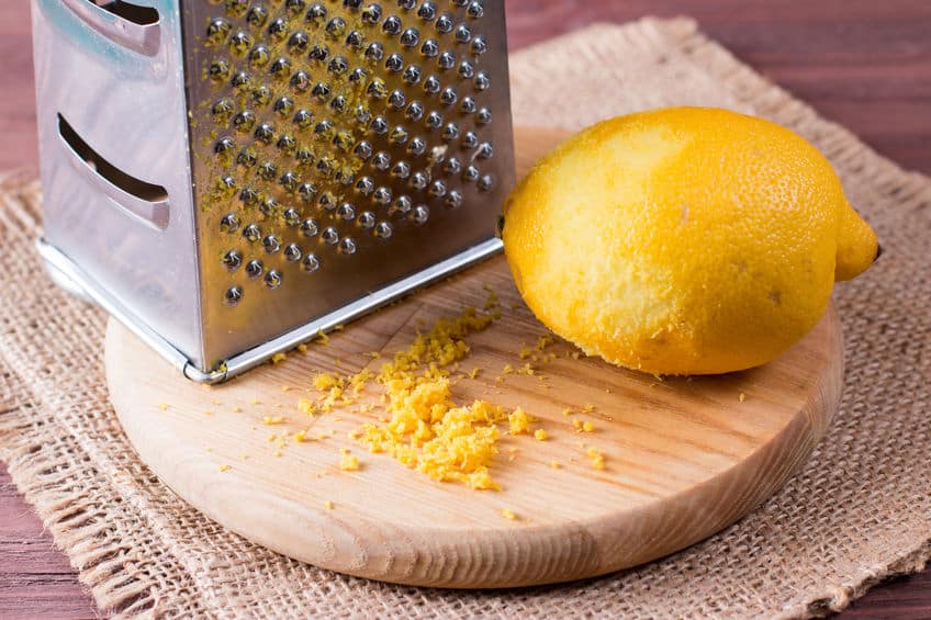 Making lemon zest wit grater displayed on wooden block via 123rf.com