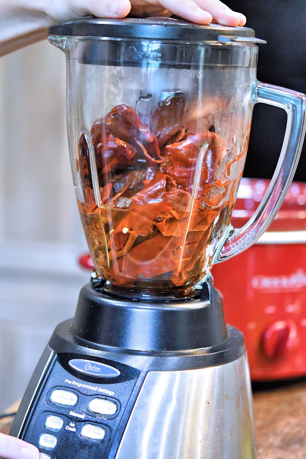 Once reconstituted, the chiles, onions and garlic are pulsed in an electric blender.