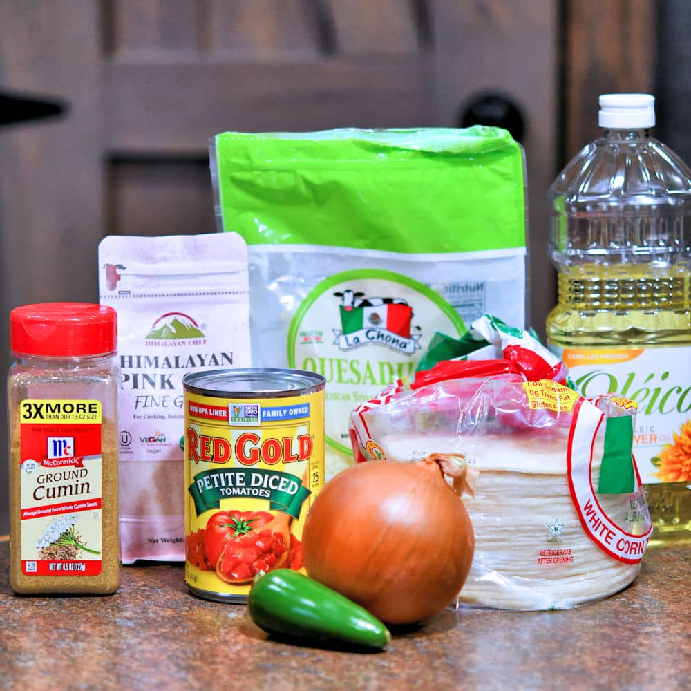 ingredients for cheese entomatadas: tortillas, onion, jalapeno, cumin, oil