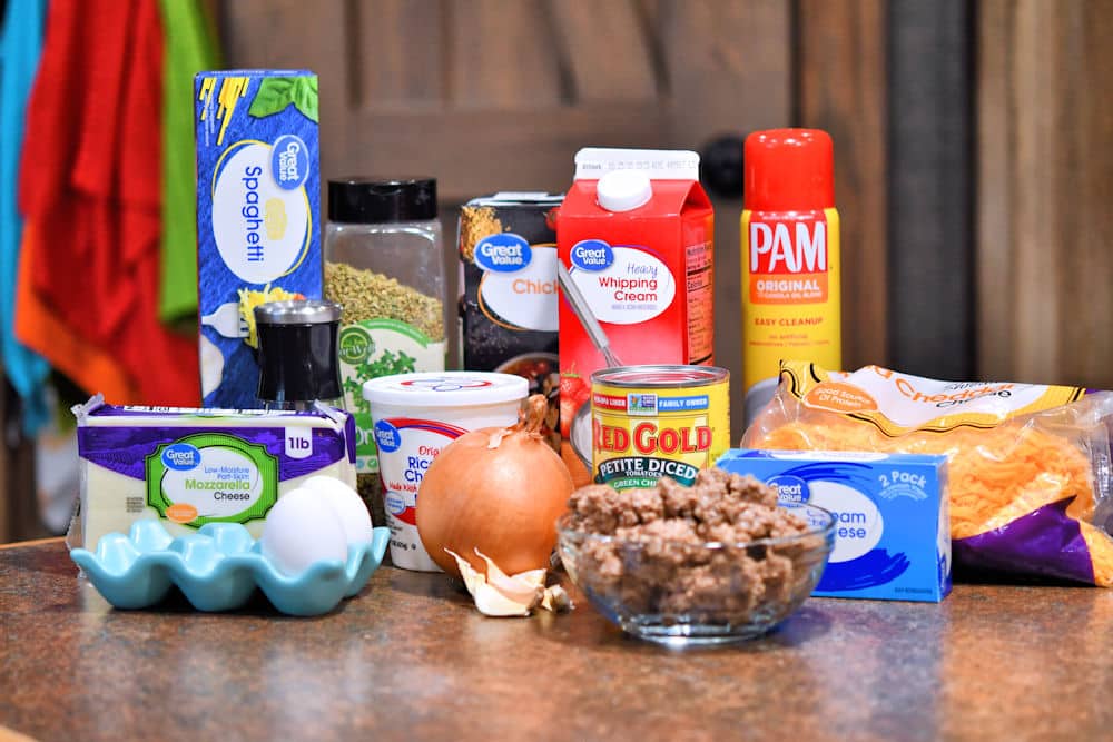 Ingredients for baked spaghetti casserole shown on a counter top, referenced in the recipe card individually