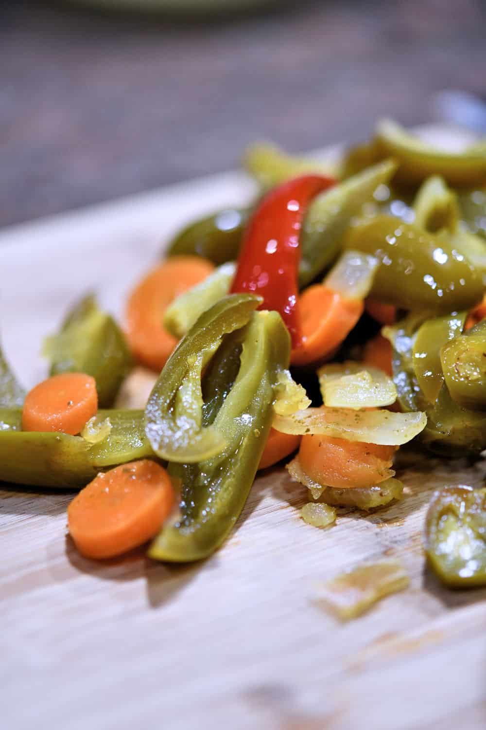 closeup of pickled sliced jalapenos, carrots and onions