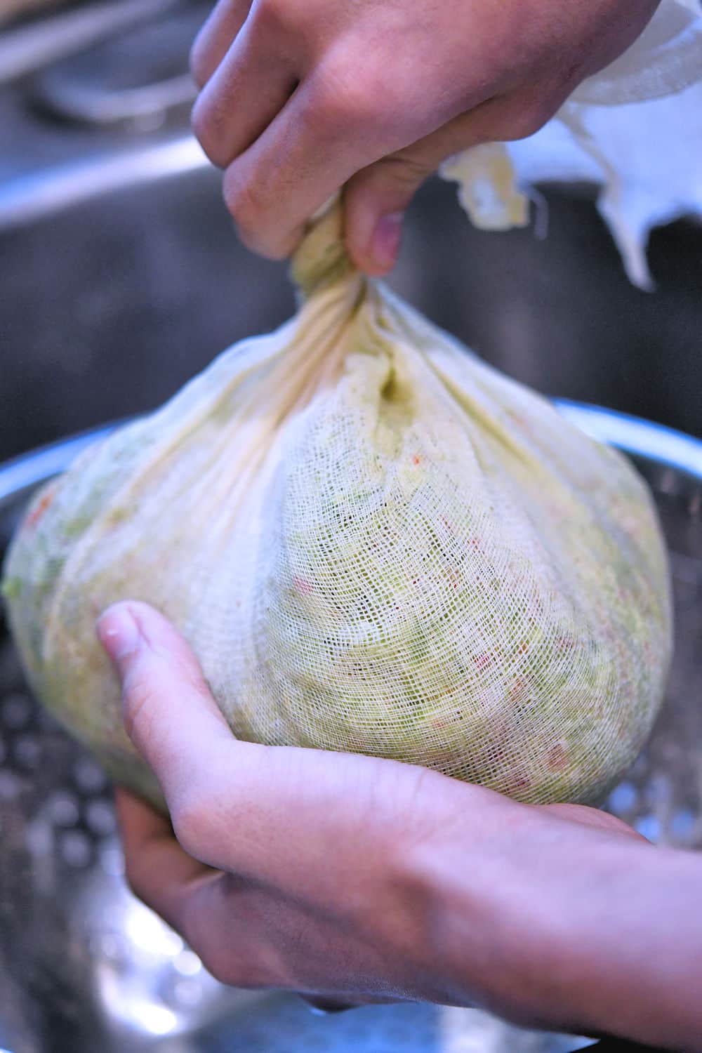 the chopped vegetables in a ball surrounded by a large piece of cheesecloth to squeeze out the excess liquid