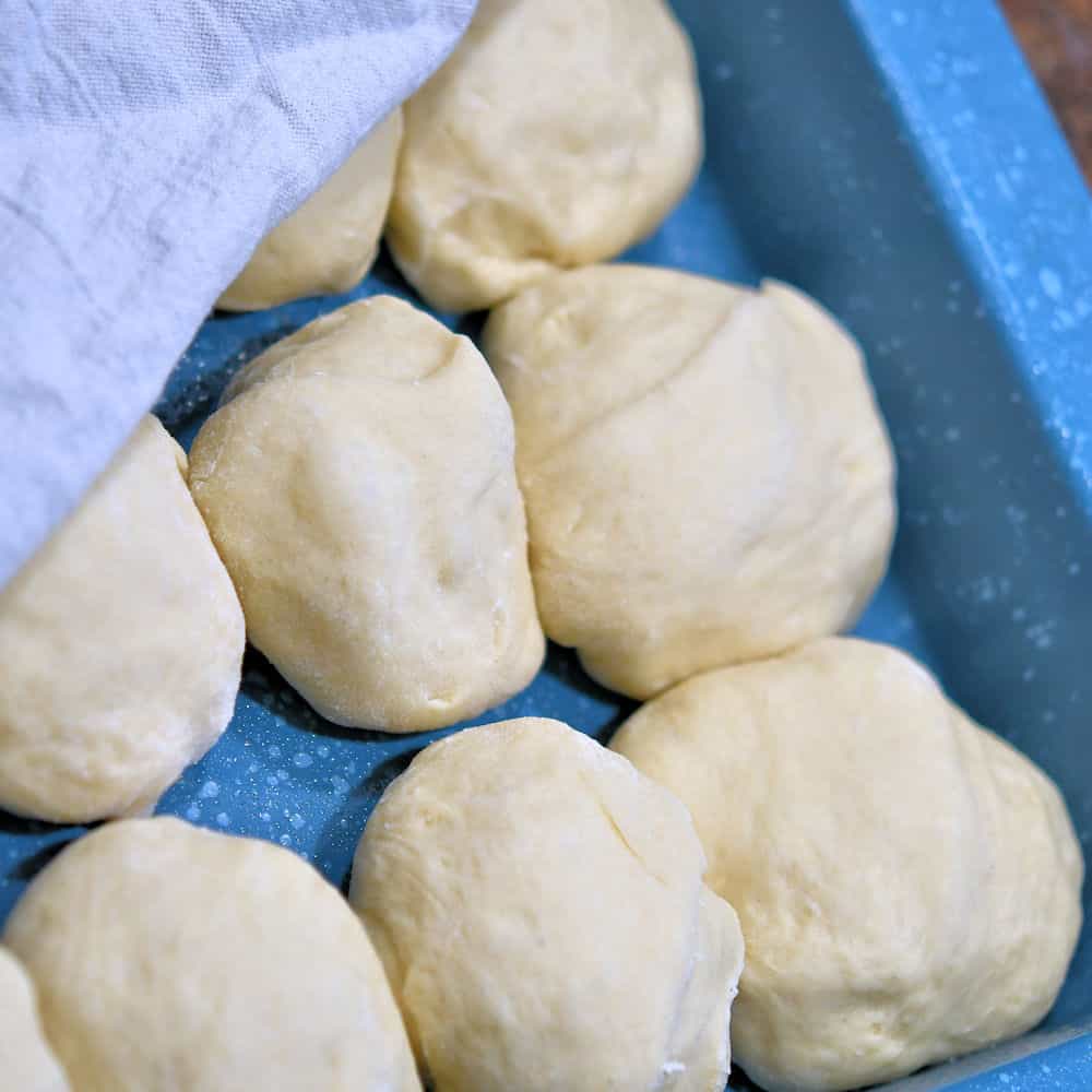 unrisen dough balls in a baking pan