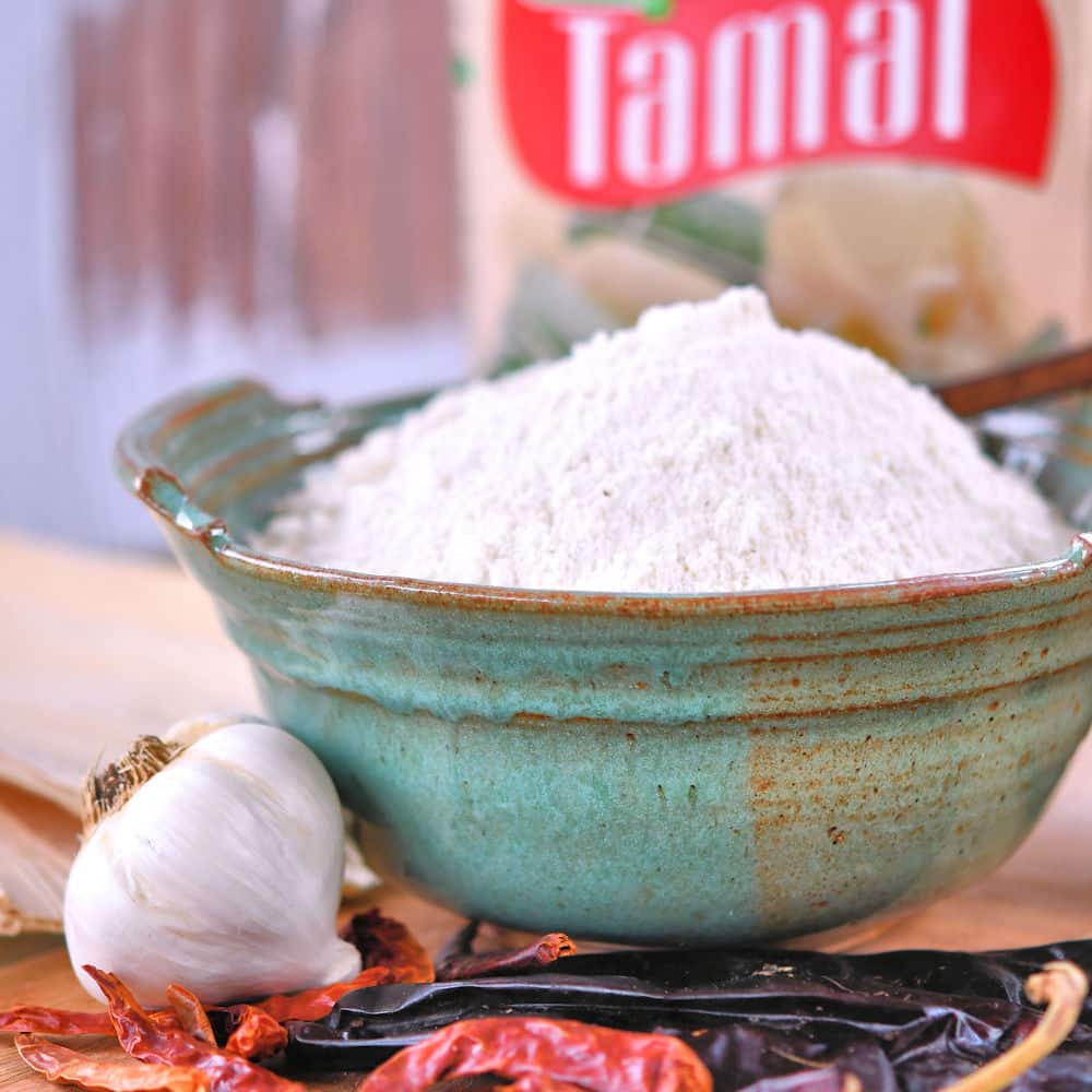 24Bite: dried red chiles, garlic and masa harina in a bowl, ready to make masa from scratch for tamales