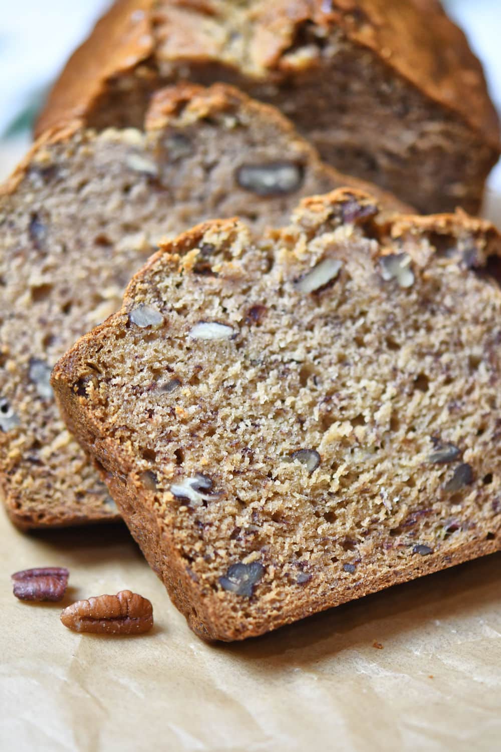 Nicely sliced dairy free banana bread with no eggs  on a parchment paper.