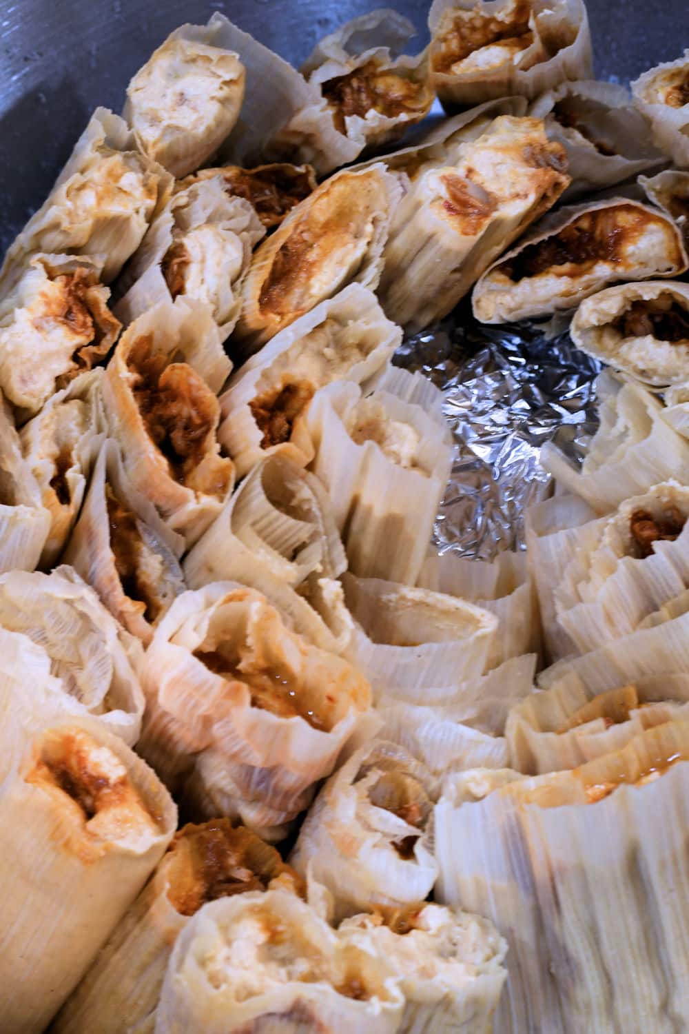 Tamales stacked in a tamale steamer, just before steaming.