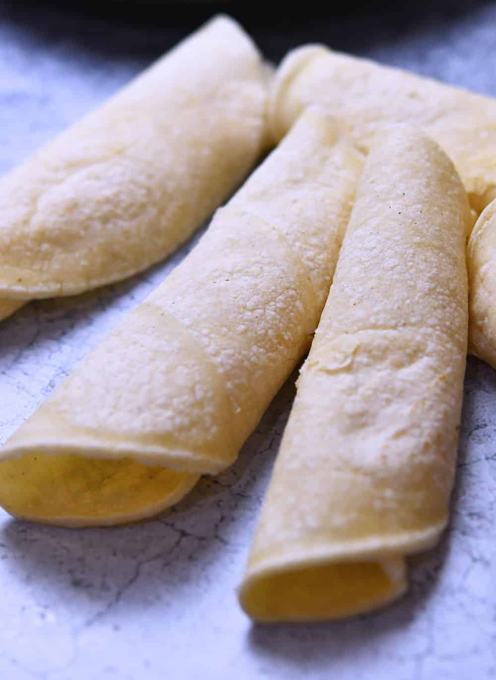 three softened tortillas, rolled into an enchilada shape