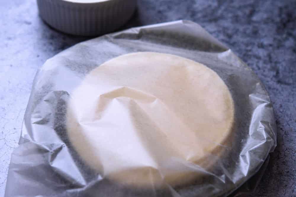 a stack of corn tortillas wrapped in waxed paper