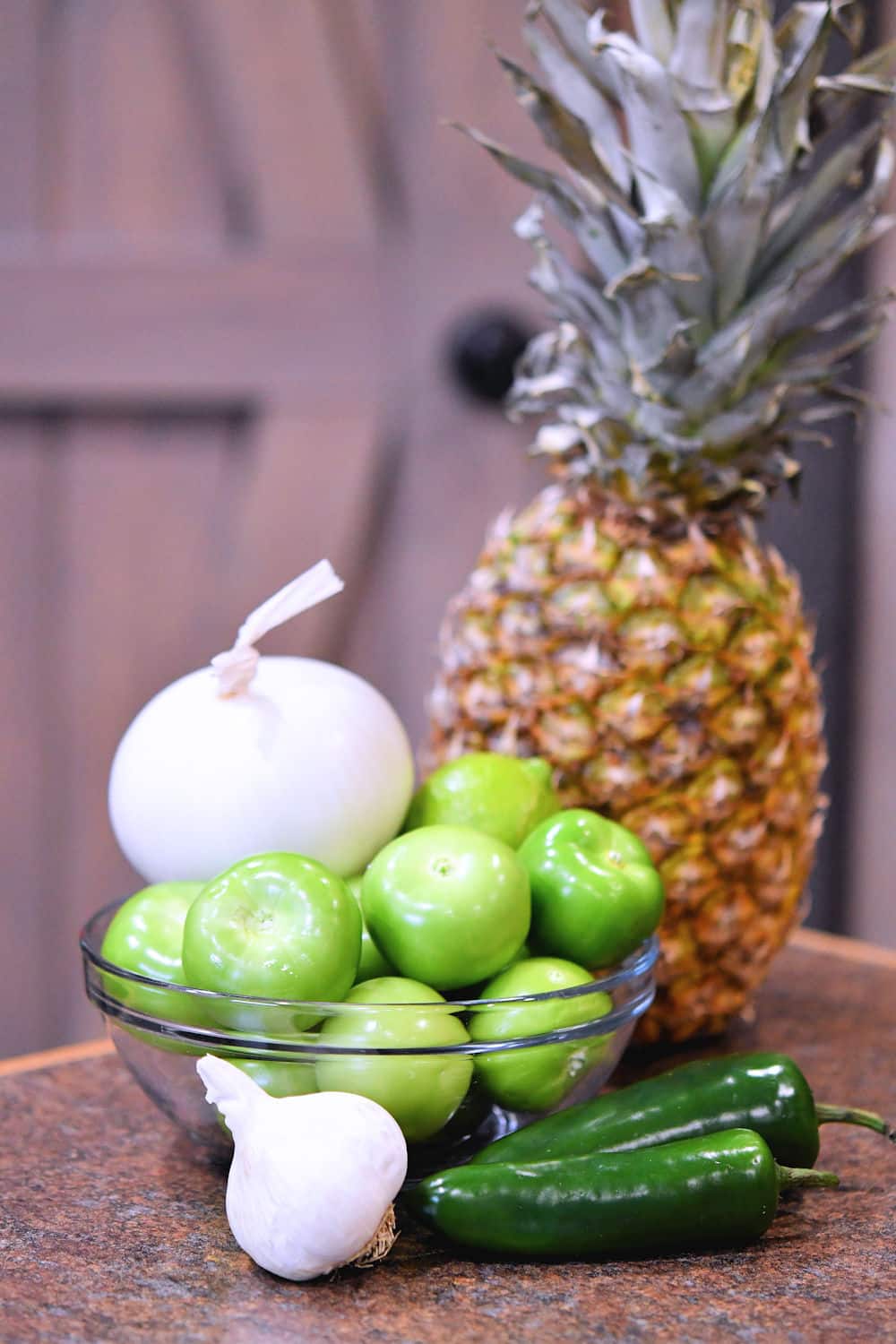 fresh ingredients for pineapple tomatillo salsa on a counter