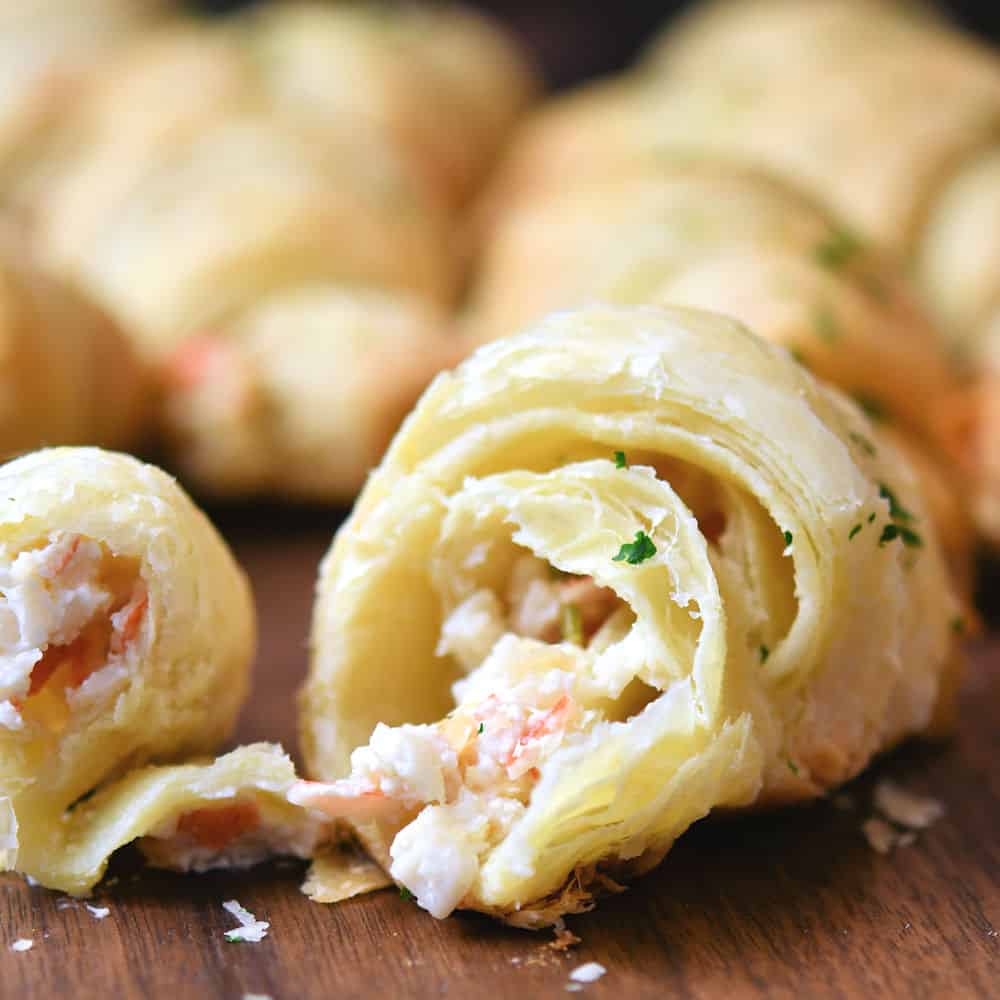 Crescent roll with crab cheese filling, pulled apart at the center to show the filling