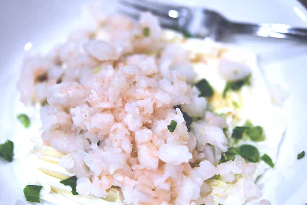 chopped shrimp in a bowl, ready to mix with cream cheese.