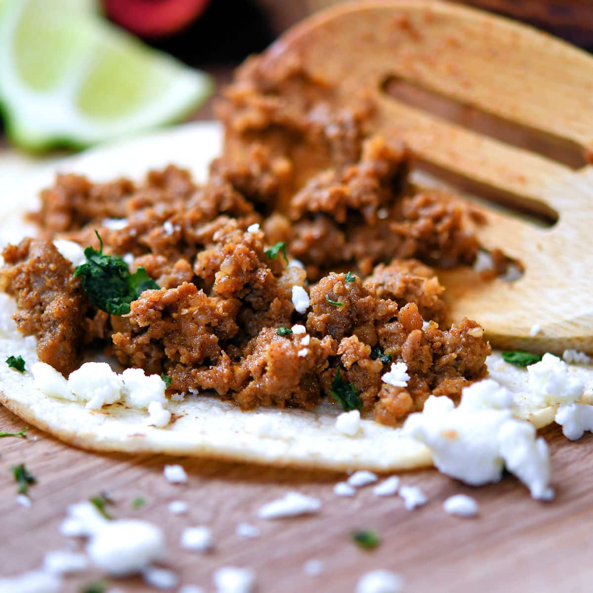 homemade fried chorizo on a corn tortilla with some crumbled queso fresco