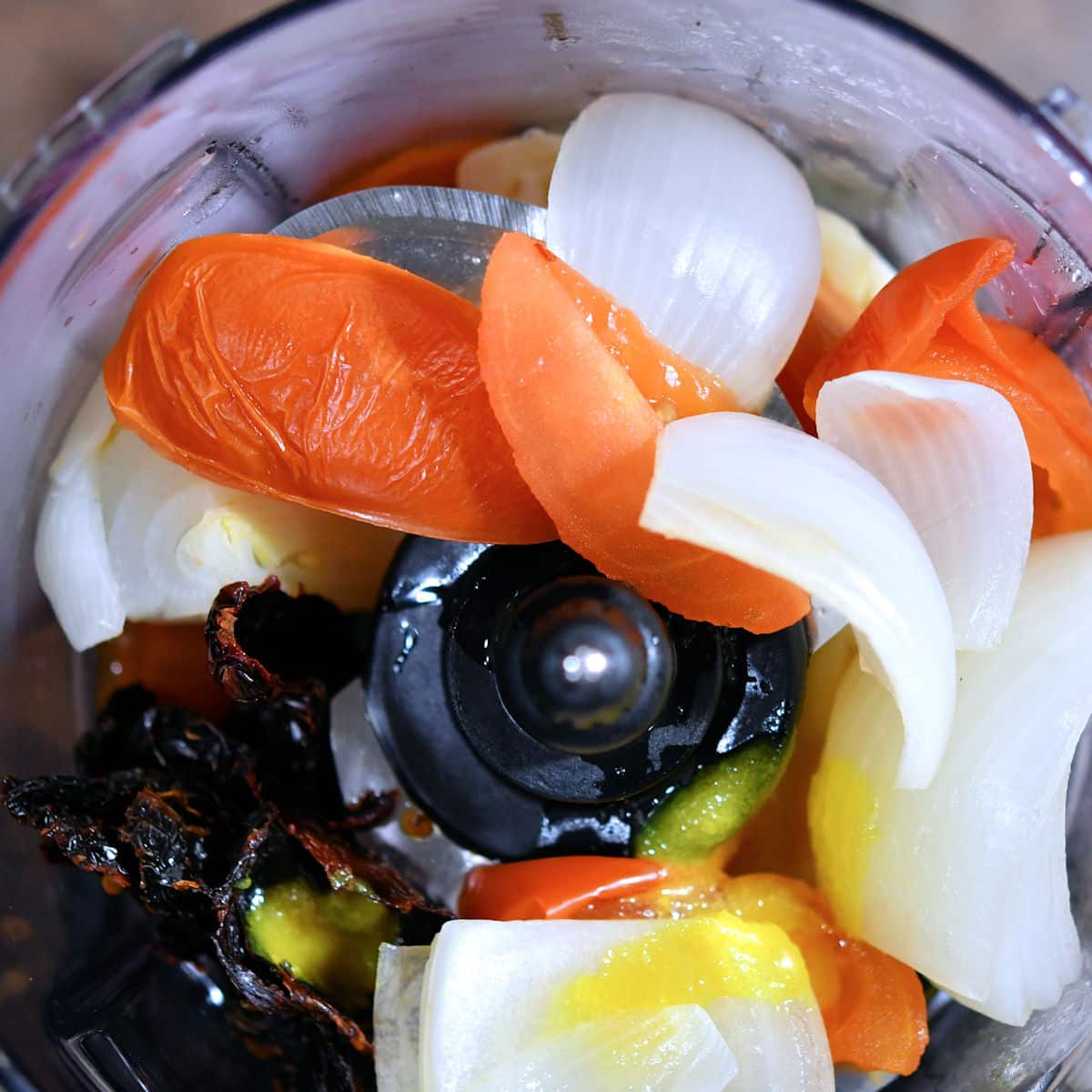 tomatoes, onions and chipotle peppers inside a food processor