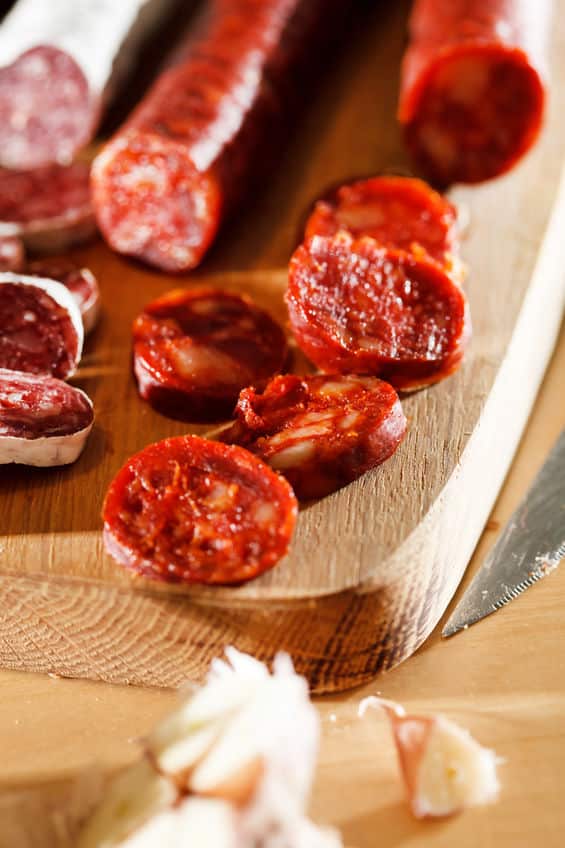 Sliced Spanish chorizo sausage on a cutting board © Maksim Shebeko via 123rf