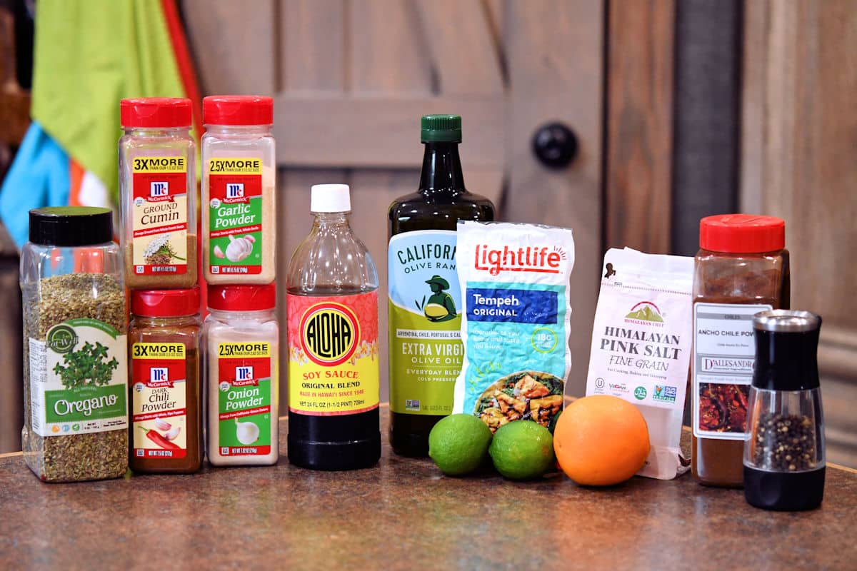 spices and citrus displayed on a countertop to be used in the fajita marinade