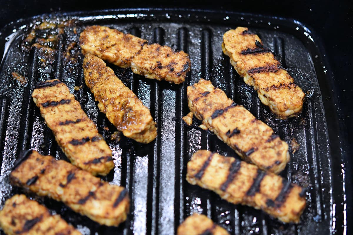 sliced tempeh in a grill pan