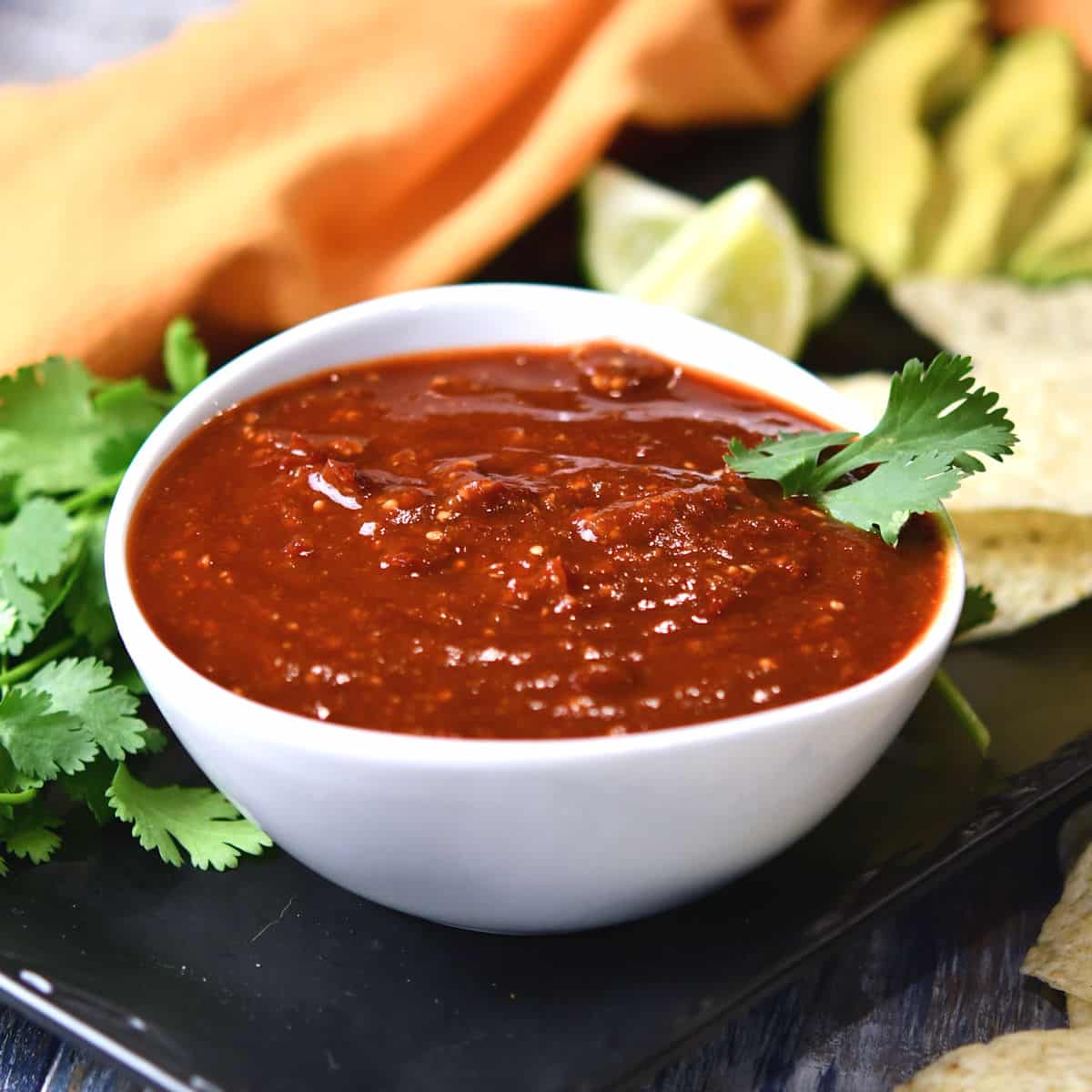 spicy tomatillo red sauce served with avocado and tortilla chips