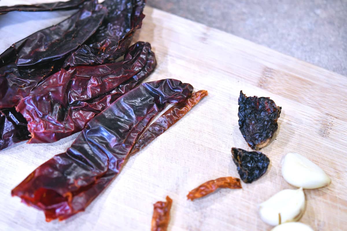 seeded dried red chile peppers on a cutting board