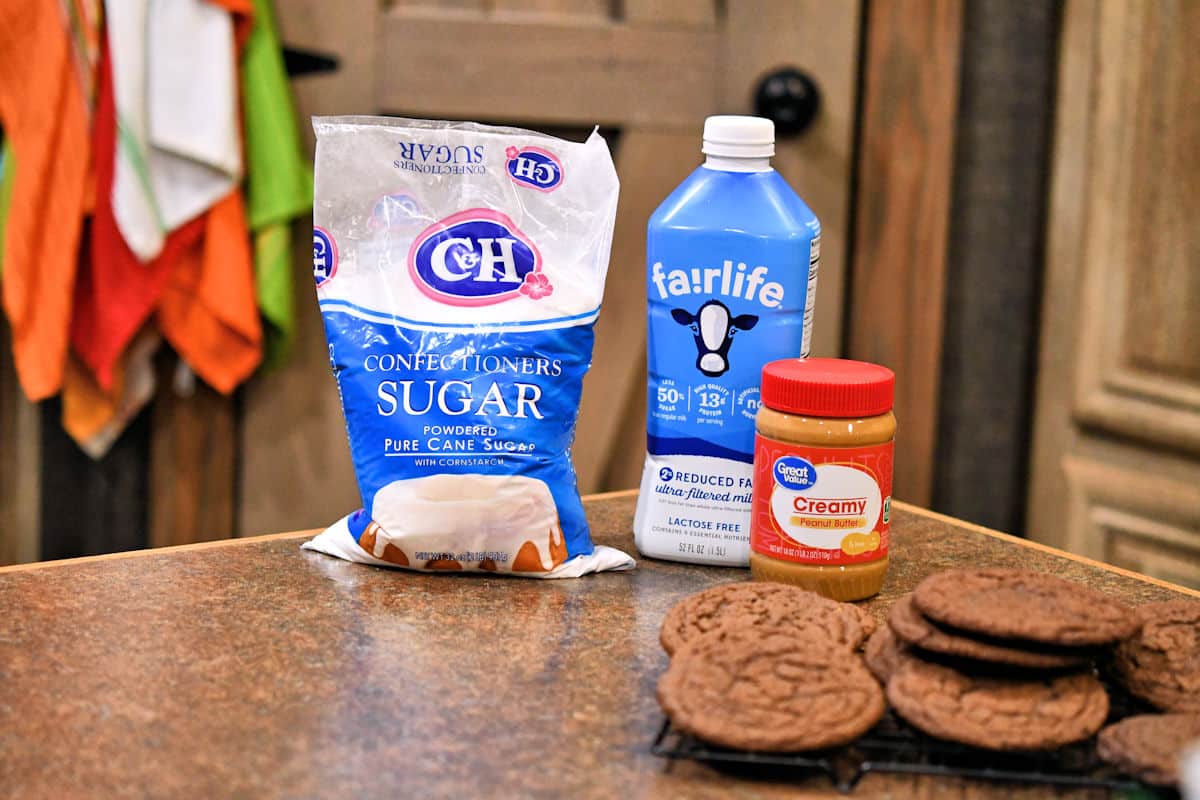 three ingredients for peanut butter frosting on a countertop