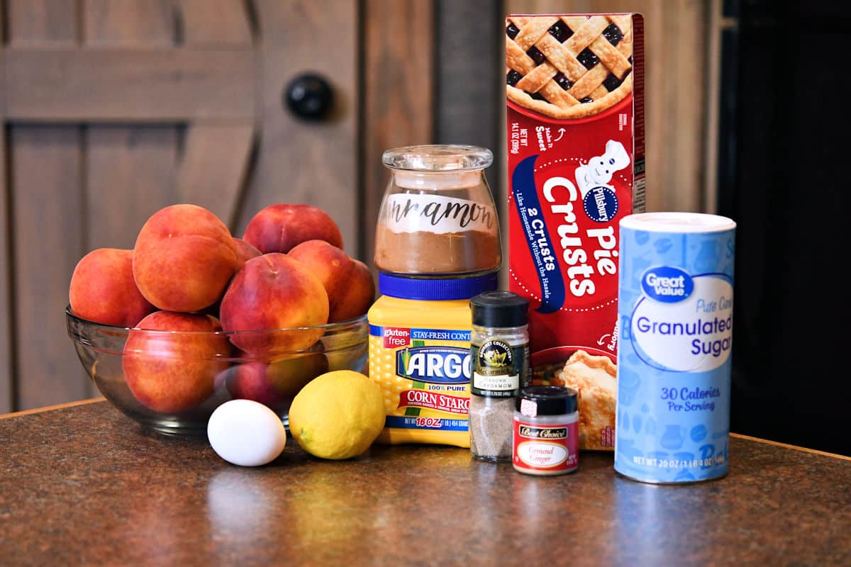 ingredients for peach pie on a kitchen countertop