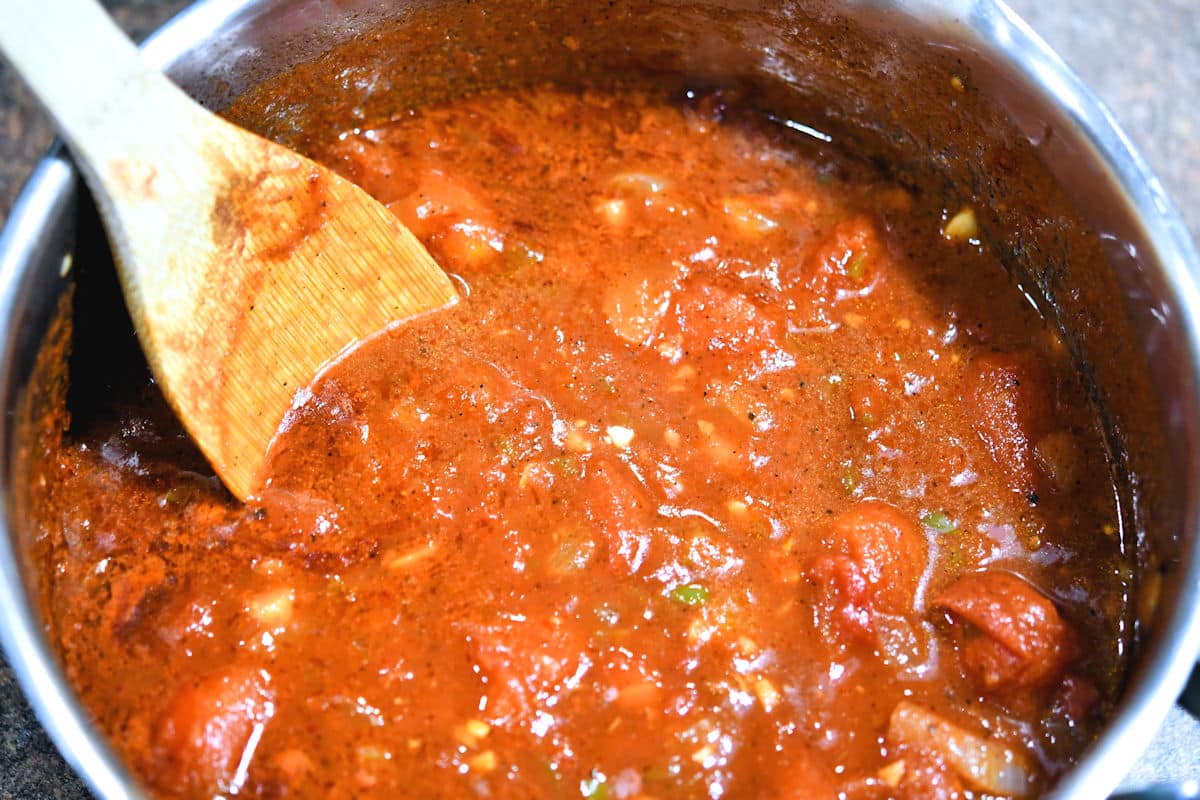 tomatoes and other fragrant vegetables simmering in a saucepan