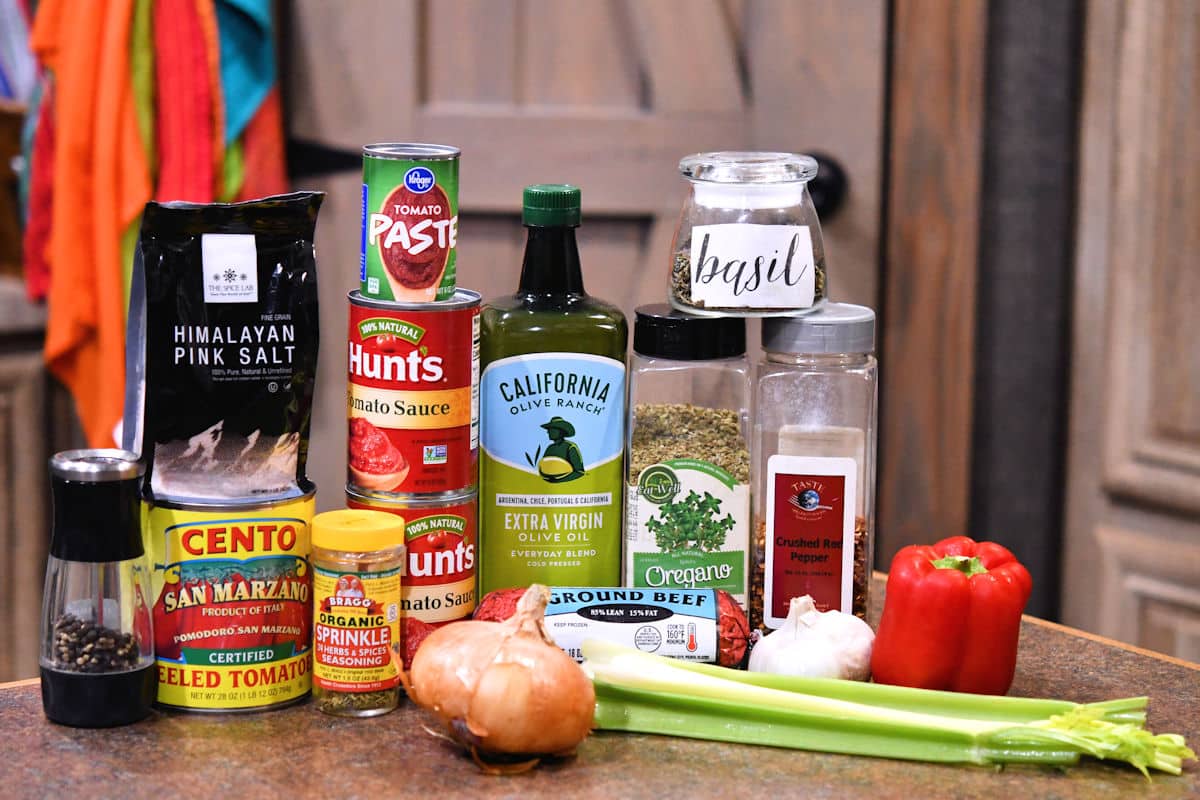 ingredients in homemade meat sauce shown in recipe on a counter