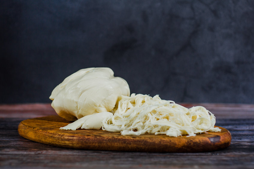 Traditional Mexican Oaxaca cheese on a wooden plate © marcoscastillo vis 123rf.com