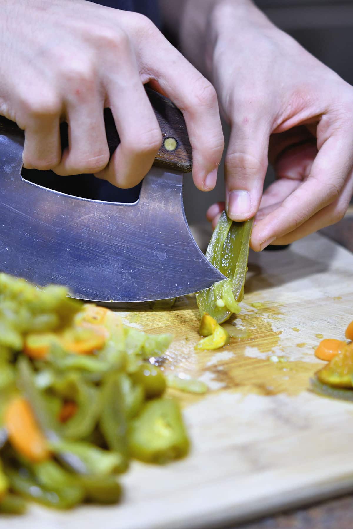 deseeding and chopping the jalapenos with an ulu knife.