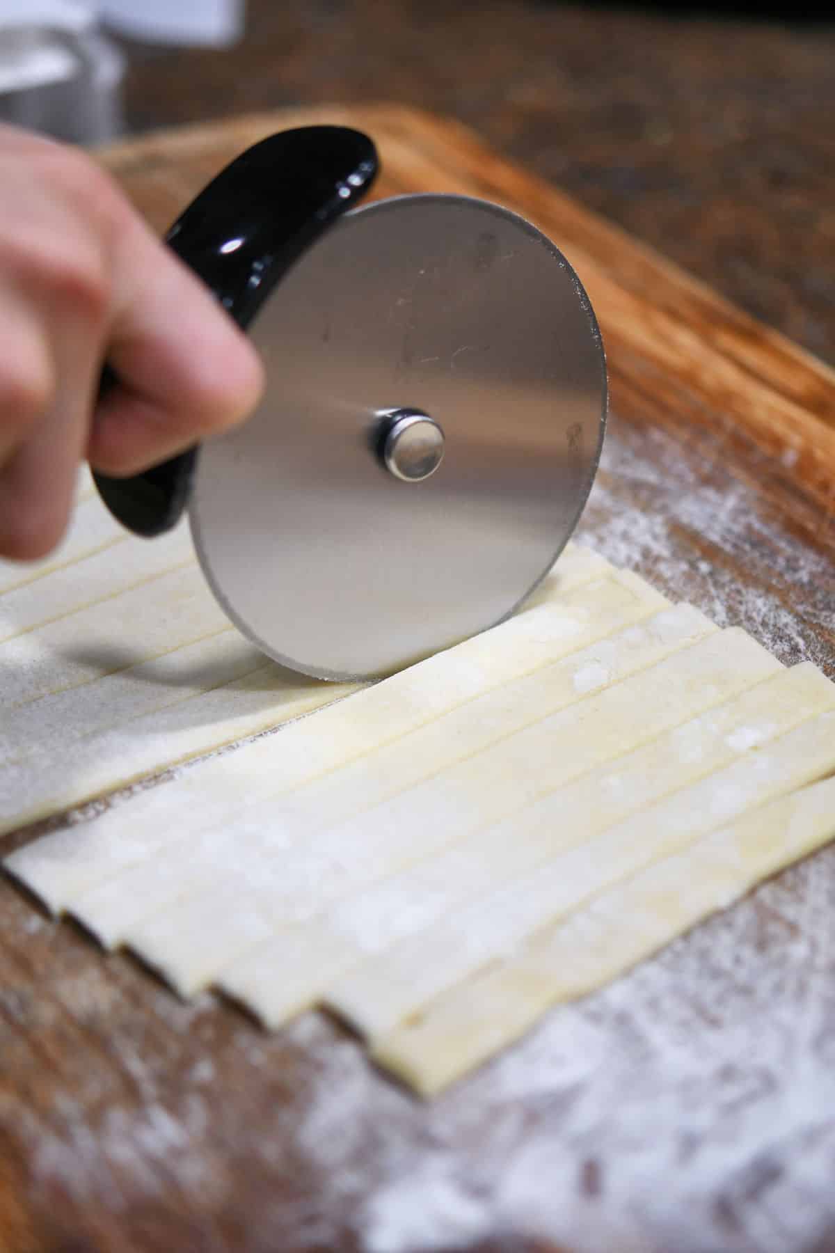 cutting puff pastry with pizza cutter