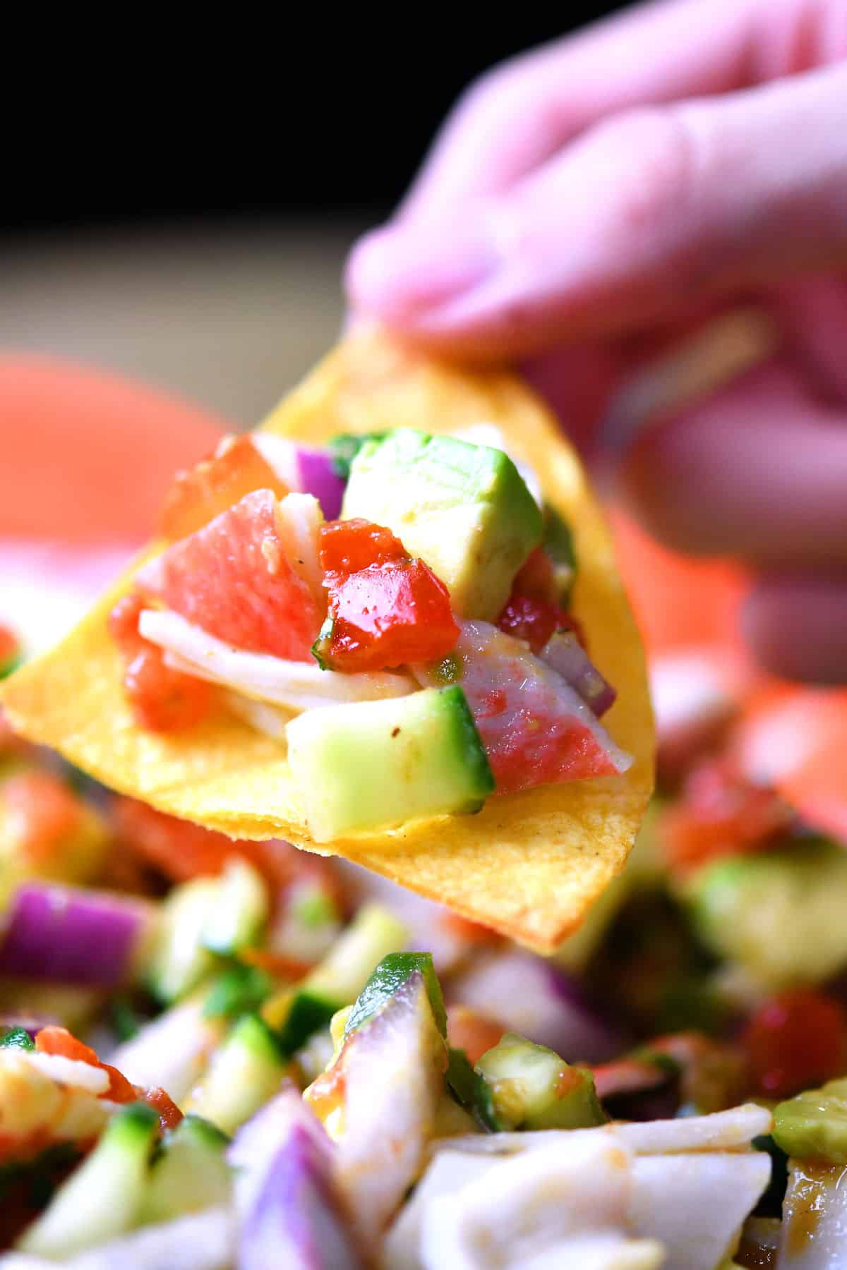 closeup of a tortilla chip with a good bit of mock crab ceviche on top