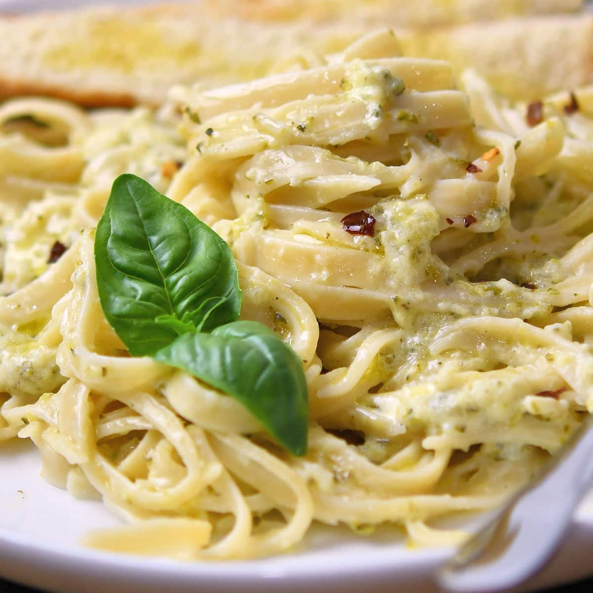 close up of zucchini pasta sauce tossed with fettucini pasta