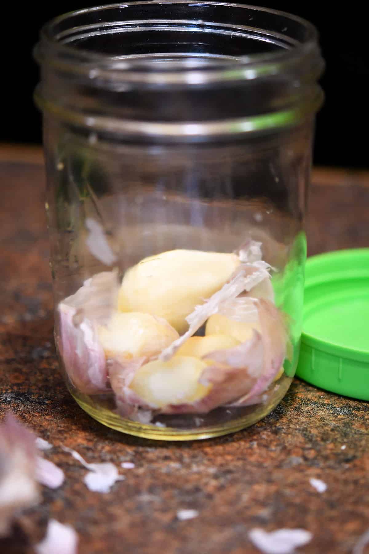 garlic cloves in a pint jar with little pieces of the peel remaining