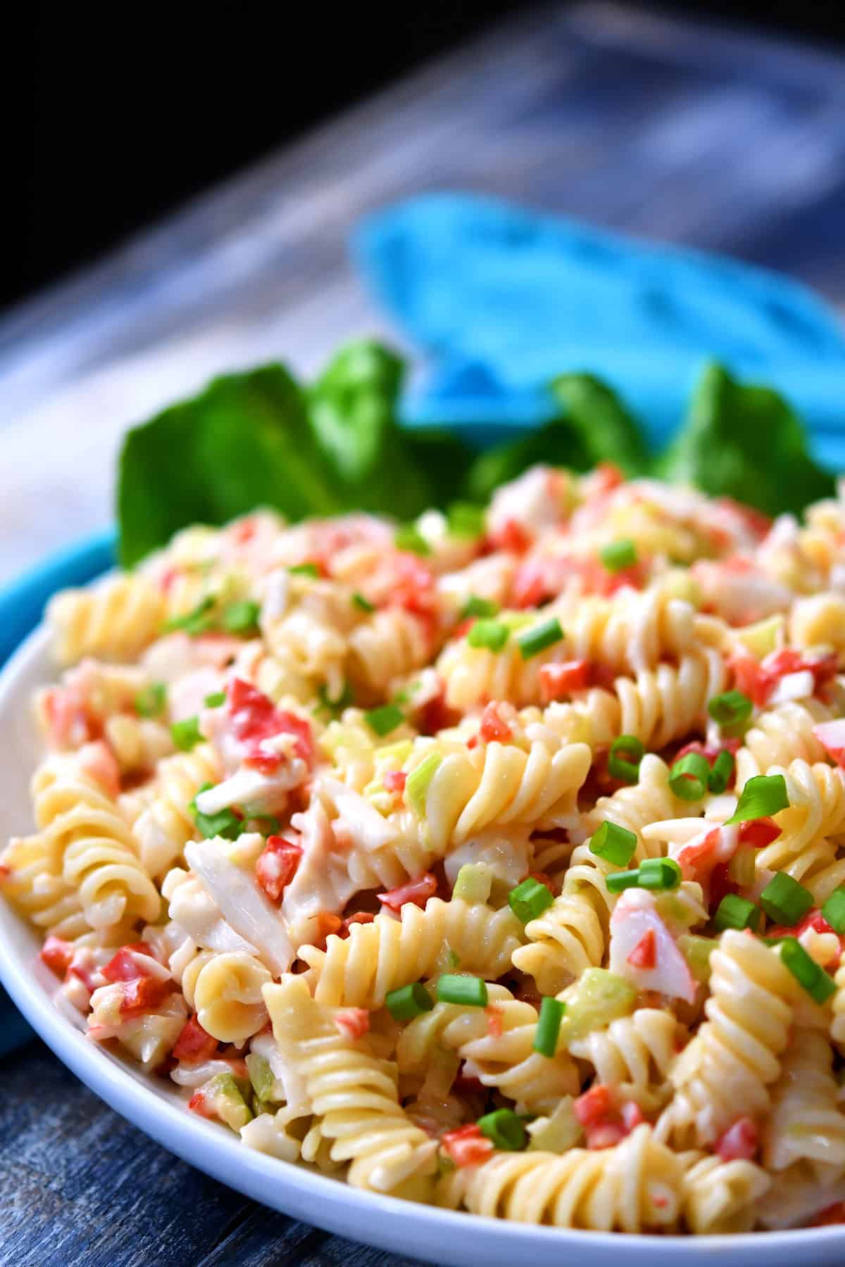 Close up of a colorful Crab Pasta Salad on a white plate