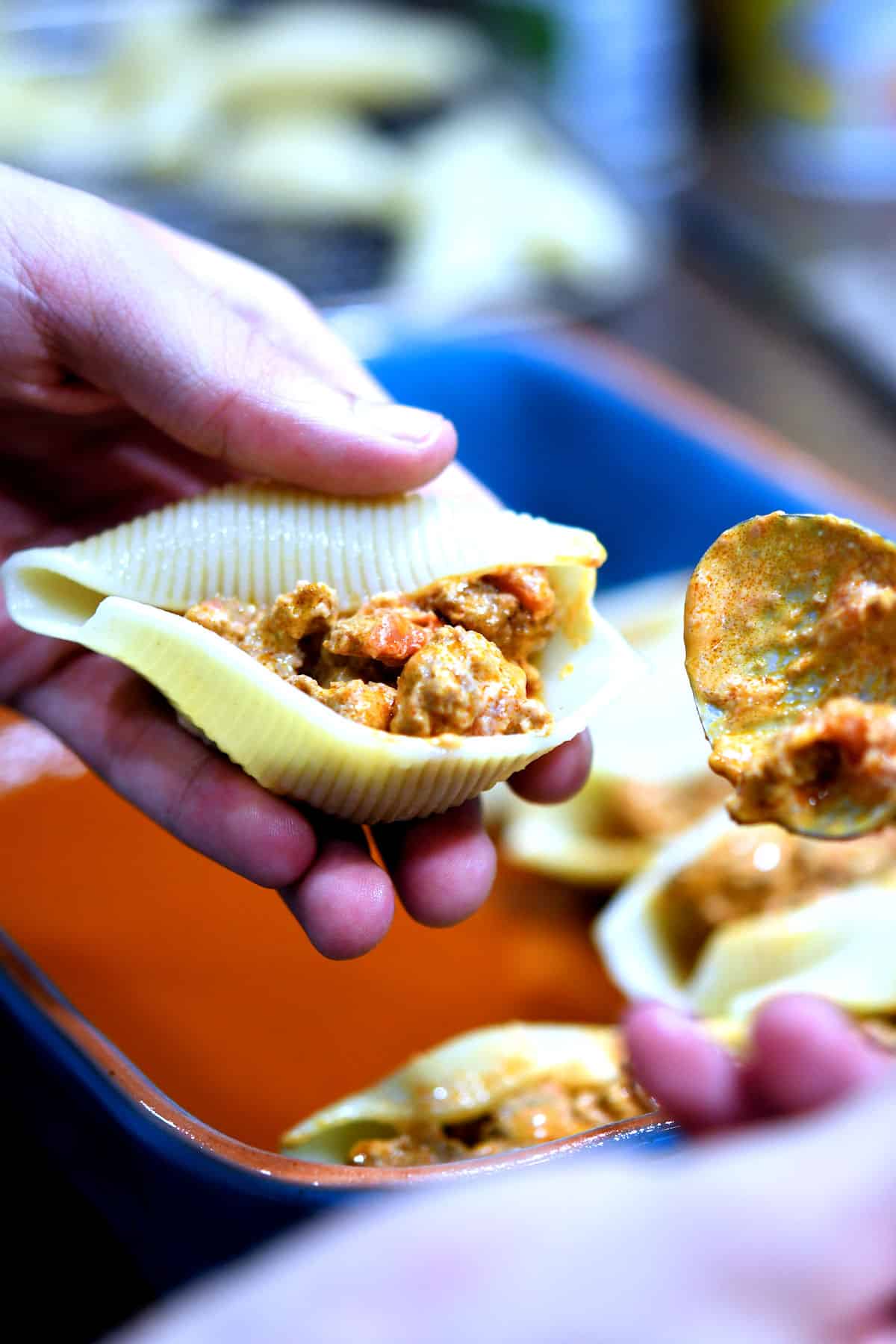 close up of adding turkey mixture to jumbo shell