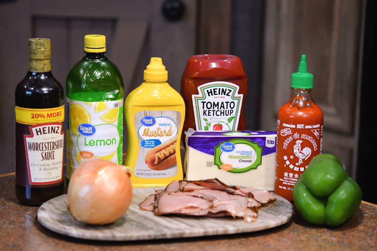 ingredients for philadelphia cheese steak pizza on a countertop