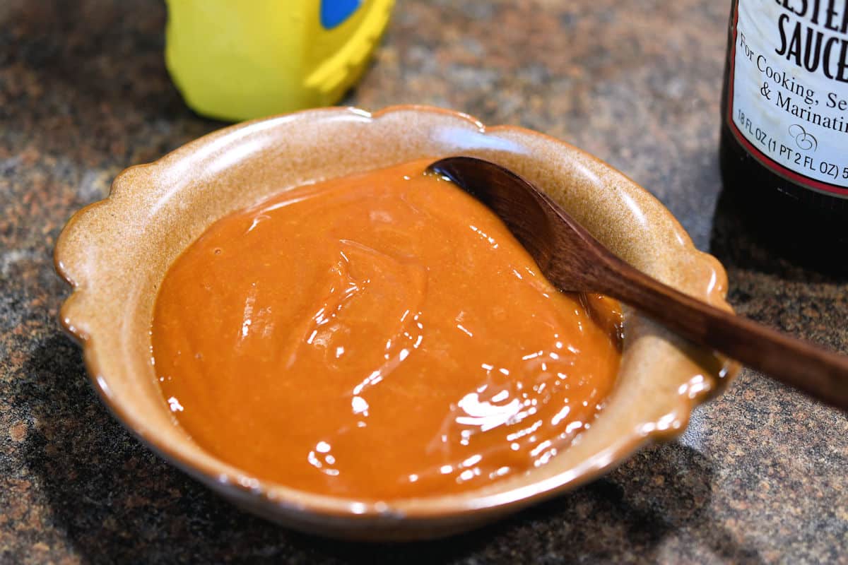 bowl of highly seasoned pizza sauce on a countertop