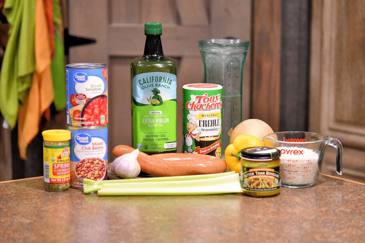 ingredients for cajun sausage and beans on a countertop