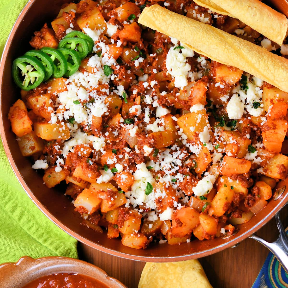 chorizo potato skillet ready to serve on a wooden table