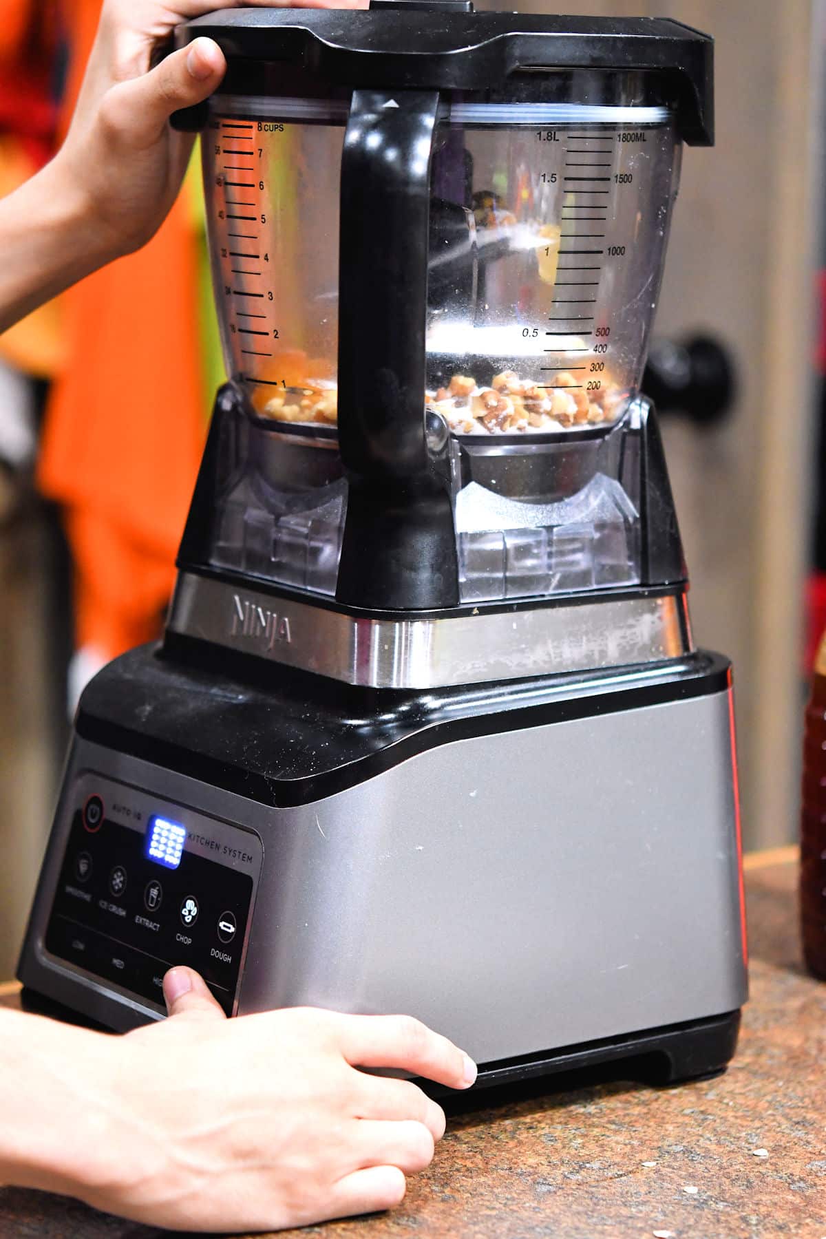 using a food processor to chop the dried apricots and walnuts