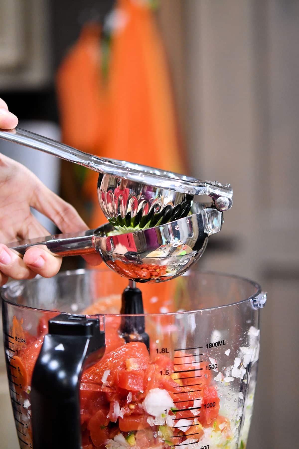 squeezing a lime for lime juice in homemade salsa